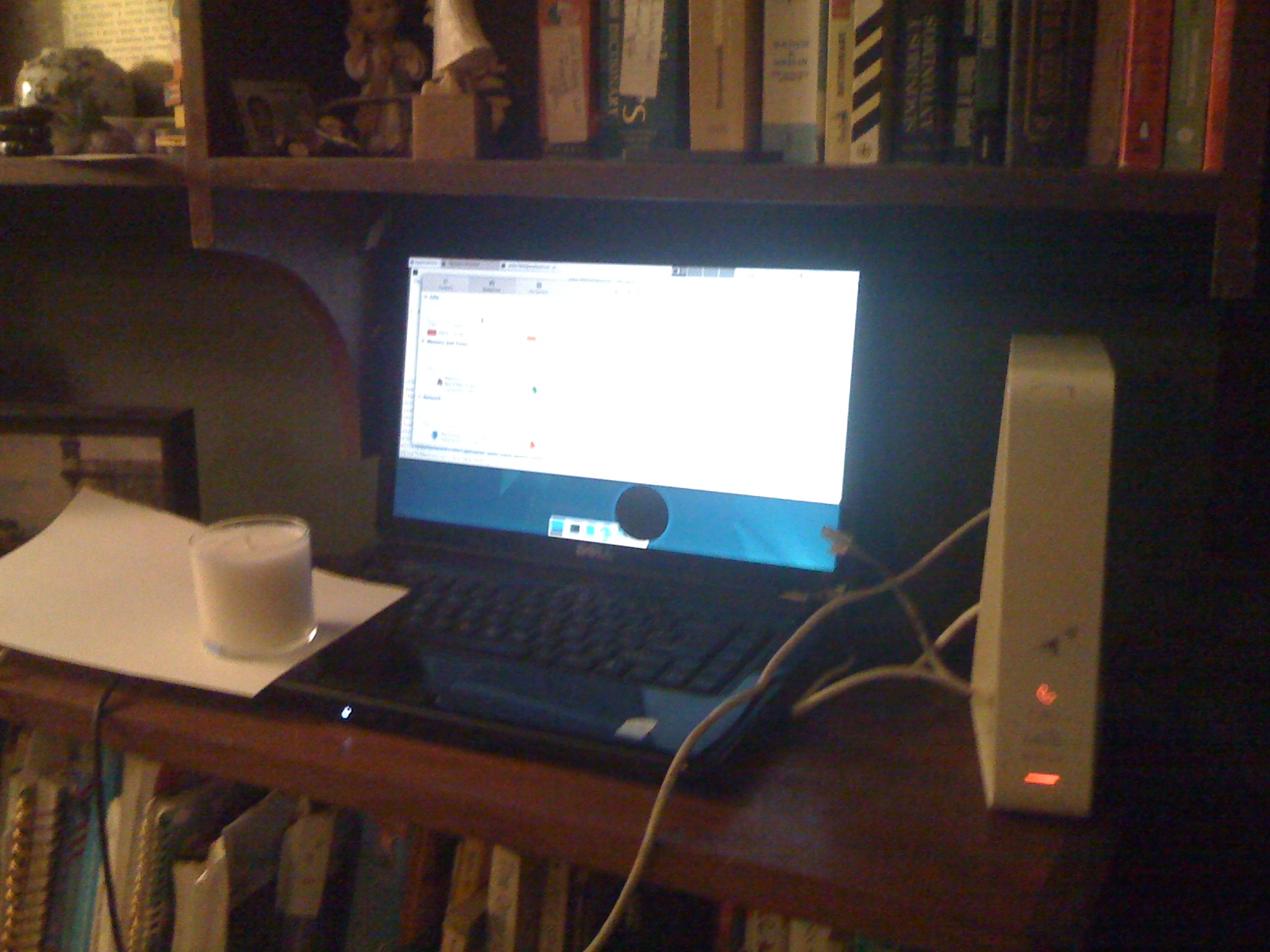 A laptop next to a router, which is acting as a webserver.