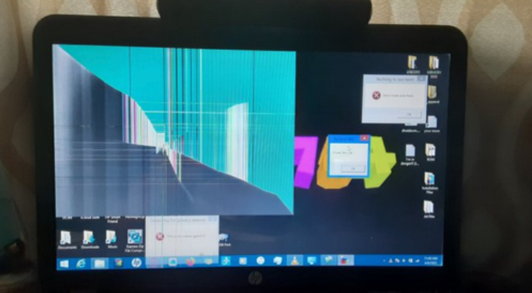 An hp laptop with a cracked display. A large square portion is affected from the top left corner.