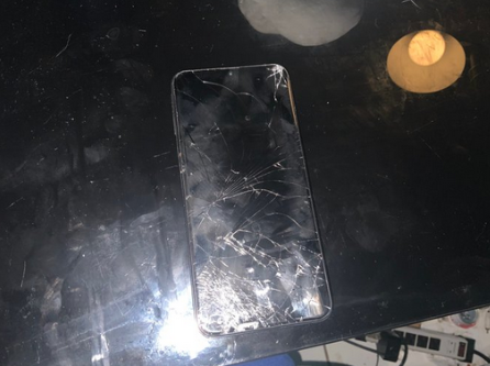 A phone with an extremely cracked touchscreen.