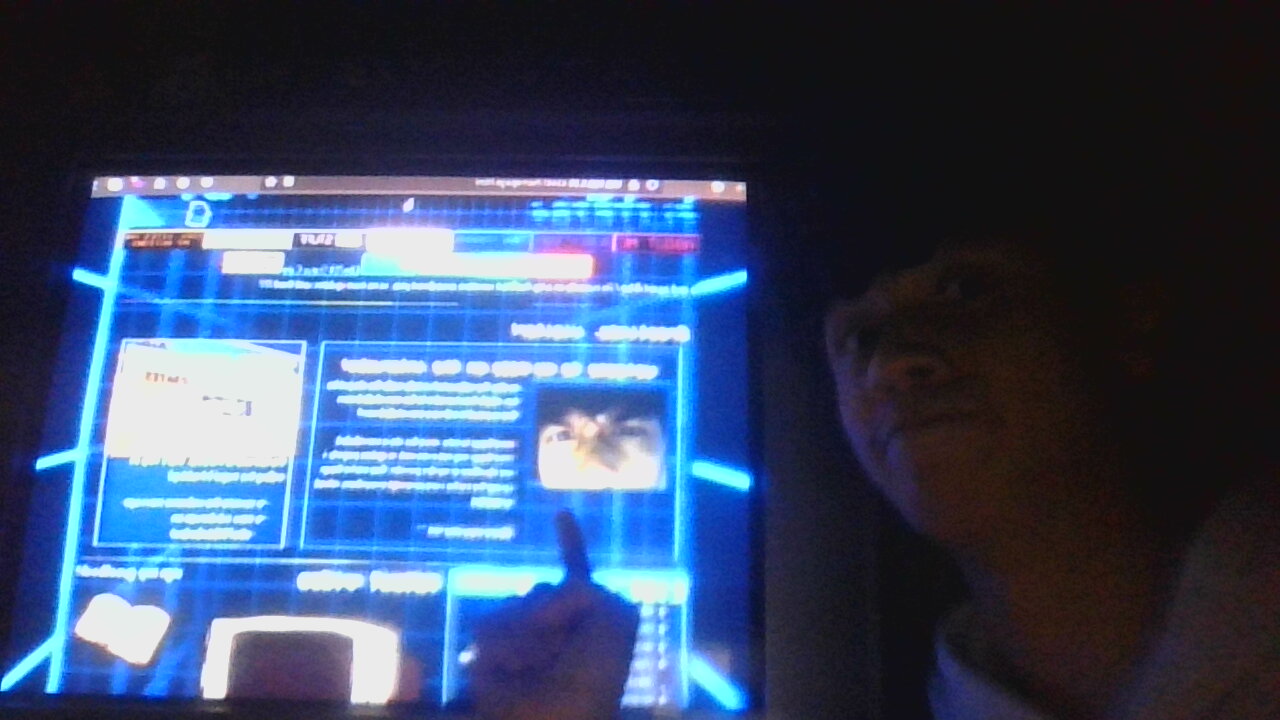 Elite784, the web. master, pointing at himself on a CRT display.